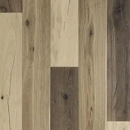 Wood flooring with varying shades of brown and tan planks, displaying wood grain patterns.