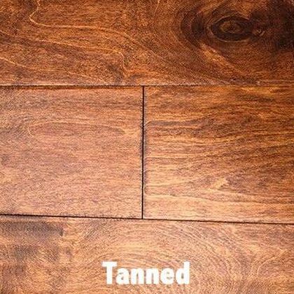 Close-up of hardwood flooring with a tanned, brown finish; visible wood grain.