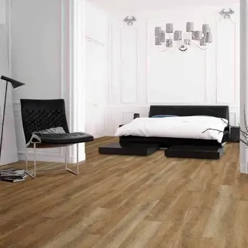 Bedroom with brown wood floors, black bed frame, black chair, and white walls.