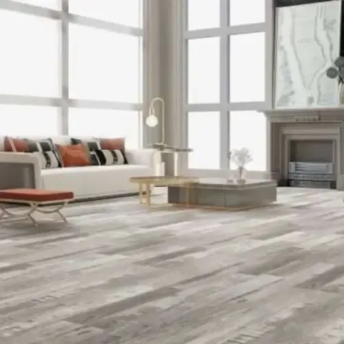 Living room with light gray wood-look flooring, white sofa, large windows, and a fireplace.
