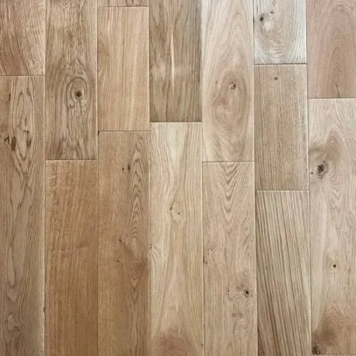 Light brown wood flooring with varied plank sizes and wood grain patterns.