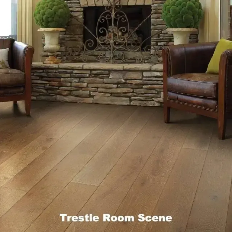 Hardwood floor in front of a stone fireplace with two leather armchairs.