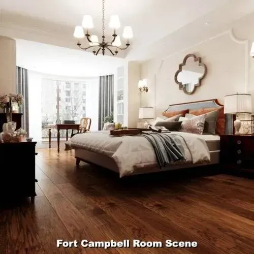 Bedroom with wooden floors, bed, and chandelier. Window and desk in background.