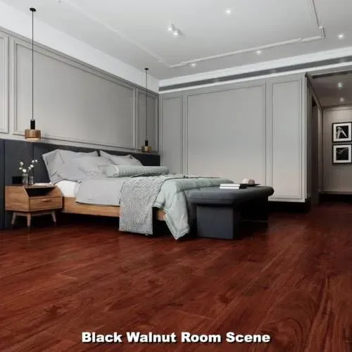 Bedroom with wood floors, bed, nightstand, and gray wall paneling. 