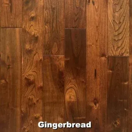 Close-up of hardwood floor planks in a warm, gingerbread brown with wood grain patterns.