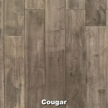 Close-up of wood flooring. The color is gray-brown with a variety of grain patterns. The name “Cougar” is below.