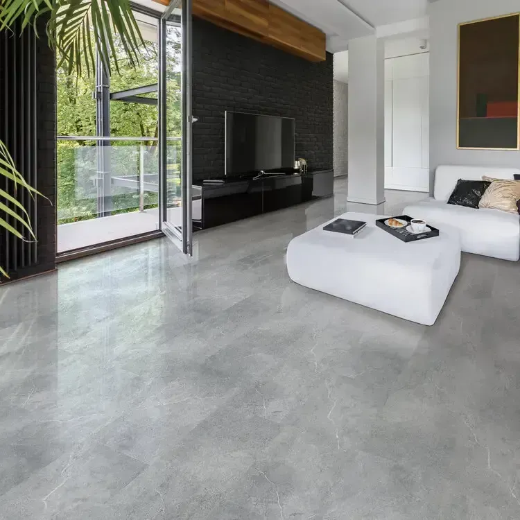 Modern living room with open balcony. Gray marble floor, white sofa, black TV, and dark wall.