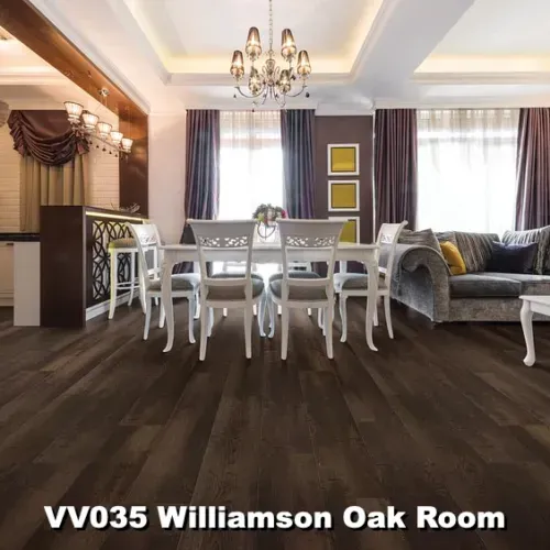 Dark wood floor in a dining room with white table, chairs, sofa, curtains, chandelier, and a brown accent wall.