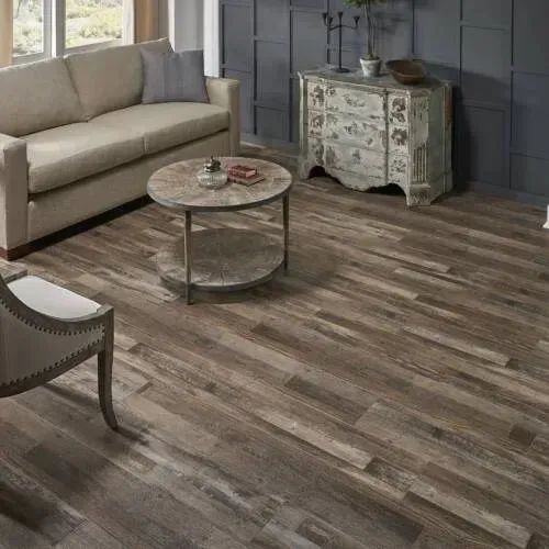Living room with wooden floors, sofa, chair, and coffee table.