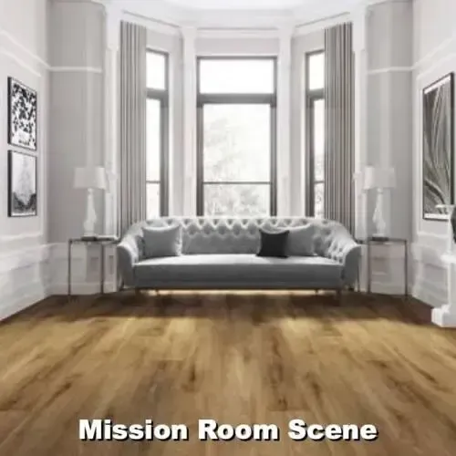 Living room with grey sofa, large windows, wood floor, and artwork on the walls.