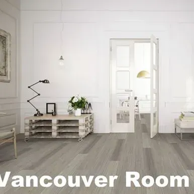 A bright room with light grey wood-look floors, white walls and a cabinet, and an open doorway.
