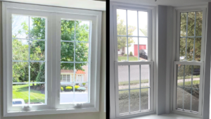 Bright room with white-framed windows overlooking a green yard and driveway.