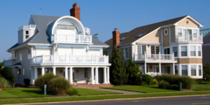 White seaside houses with porches and balconies under a clear blue sky