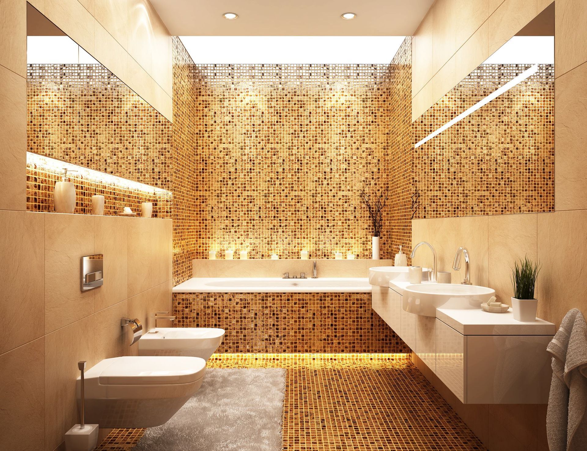 Modern bathroom with beige and gold tile, a floating vanity, toilet, and soaking tub