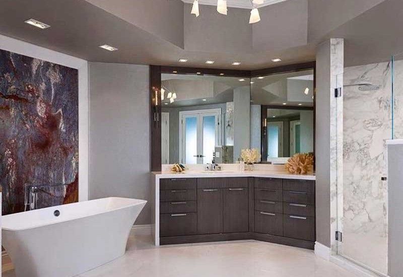 Modern gray bathroom with a bathtub, vanity, and shower