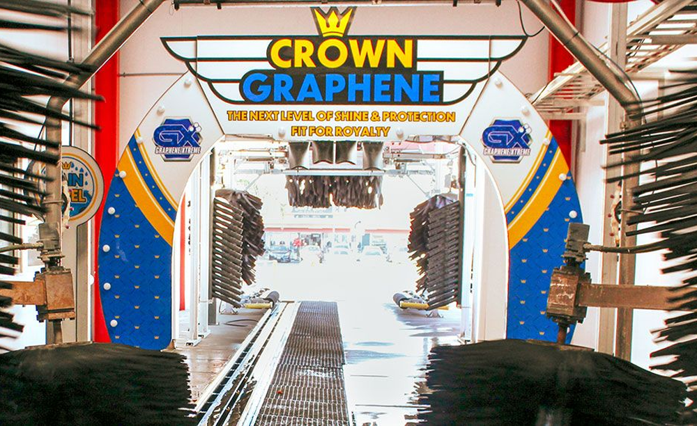 Inside a car wash: Crown Graphene archway with brushes, looking towards the exit. Blue and white colors.