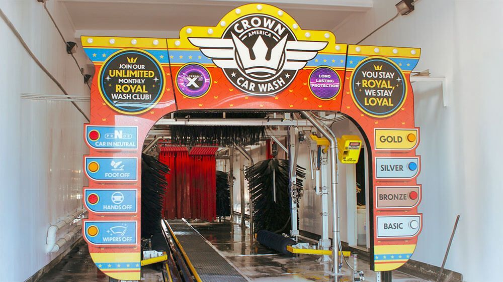 A car wash with a sign that says `` crown car wash '' on it.