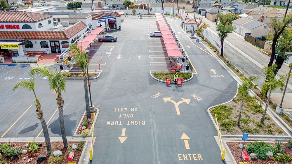 An aerial view of a parking lot with a sign that says enter
