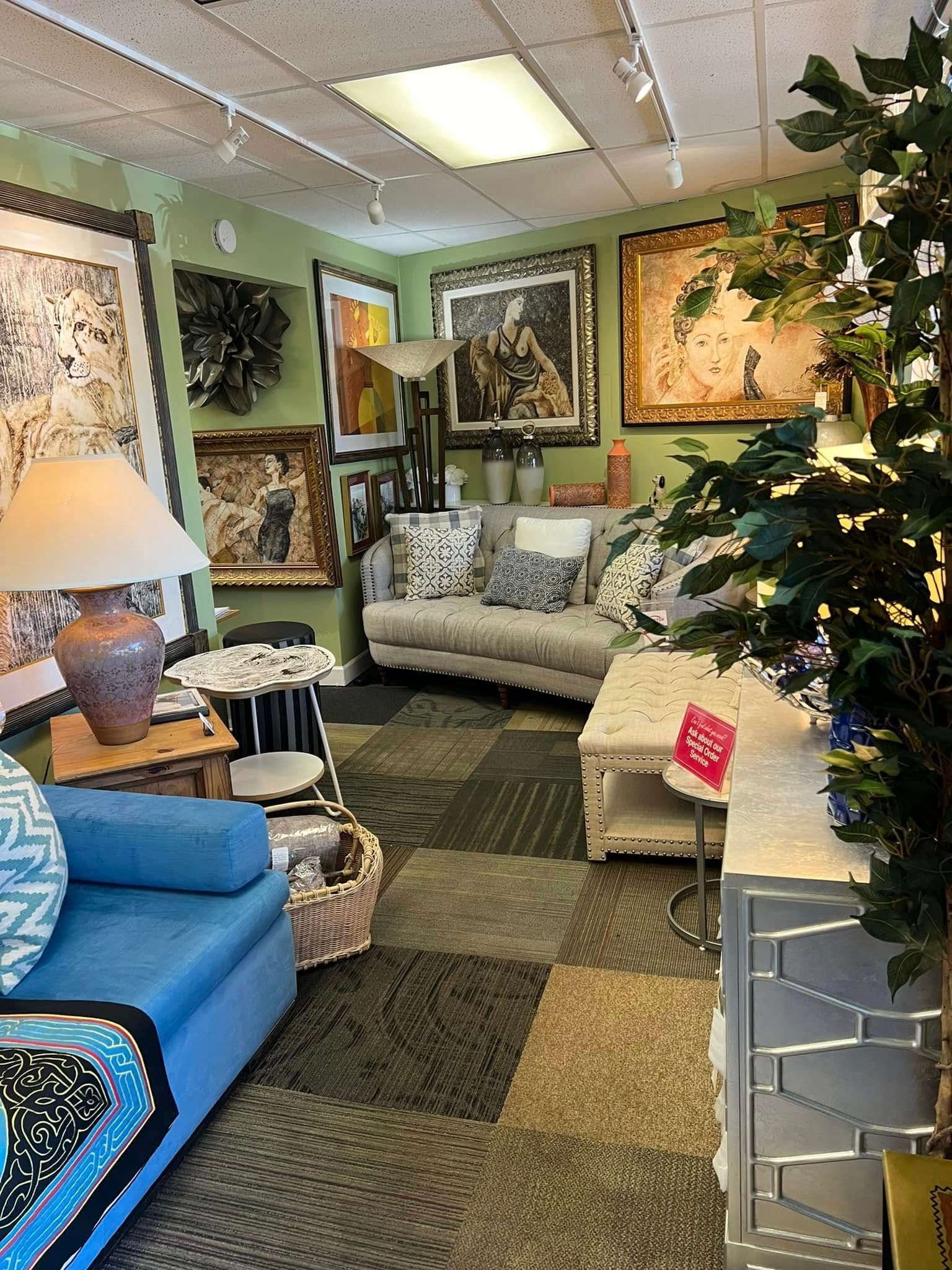 Cozy furniture showroom with sofas, lamps, framed art, plants, and a lit Christmas tree.