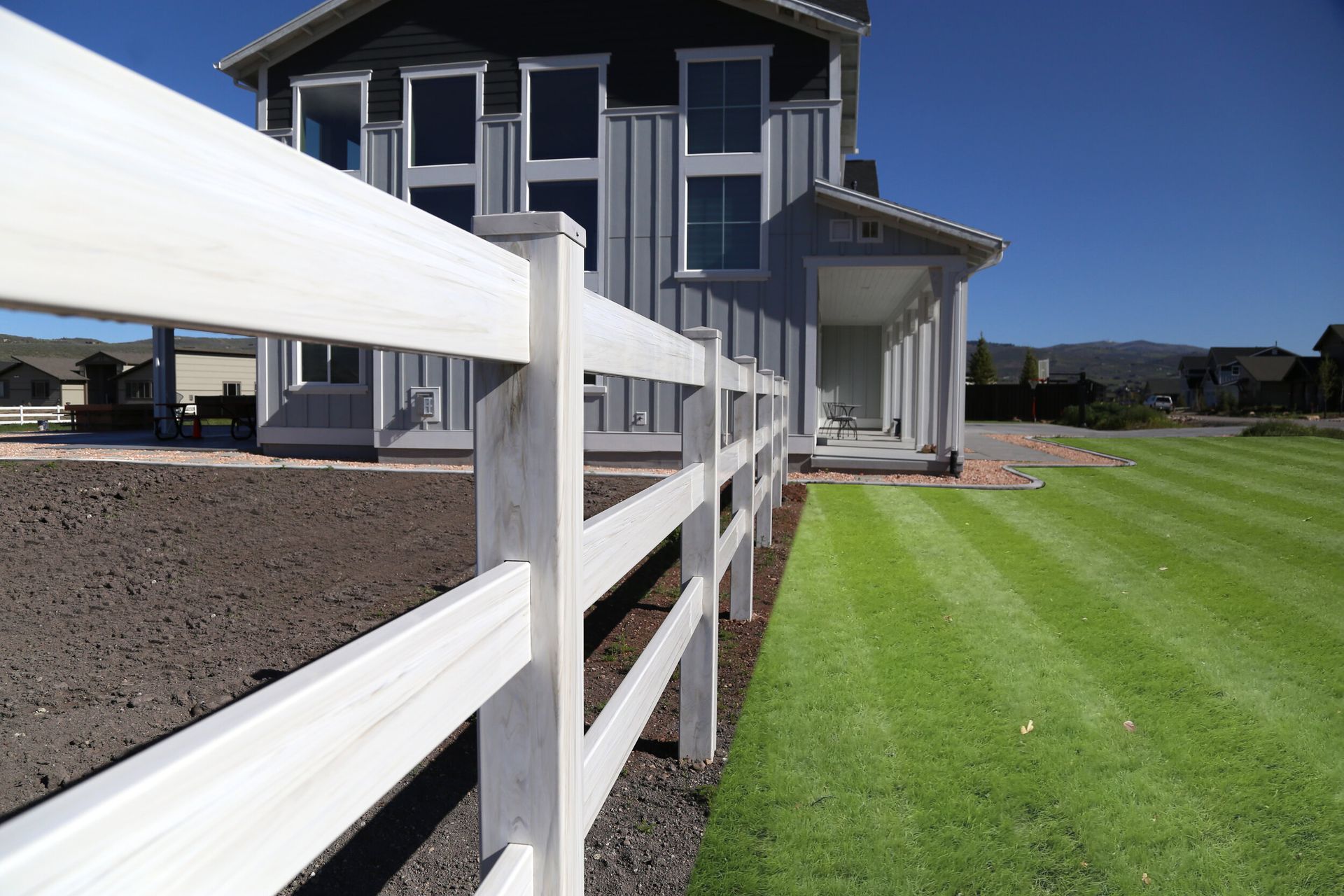 A house with a white fence in front of it