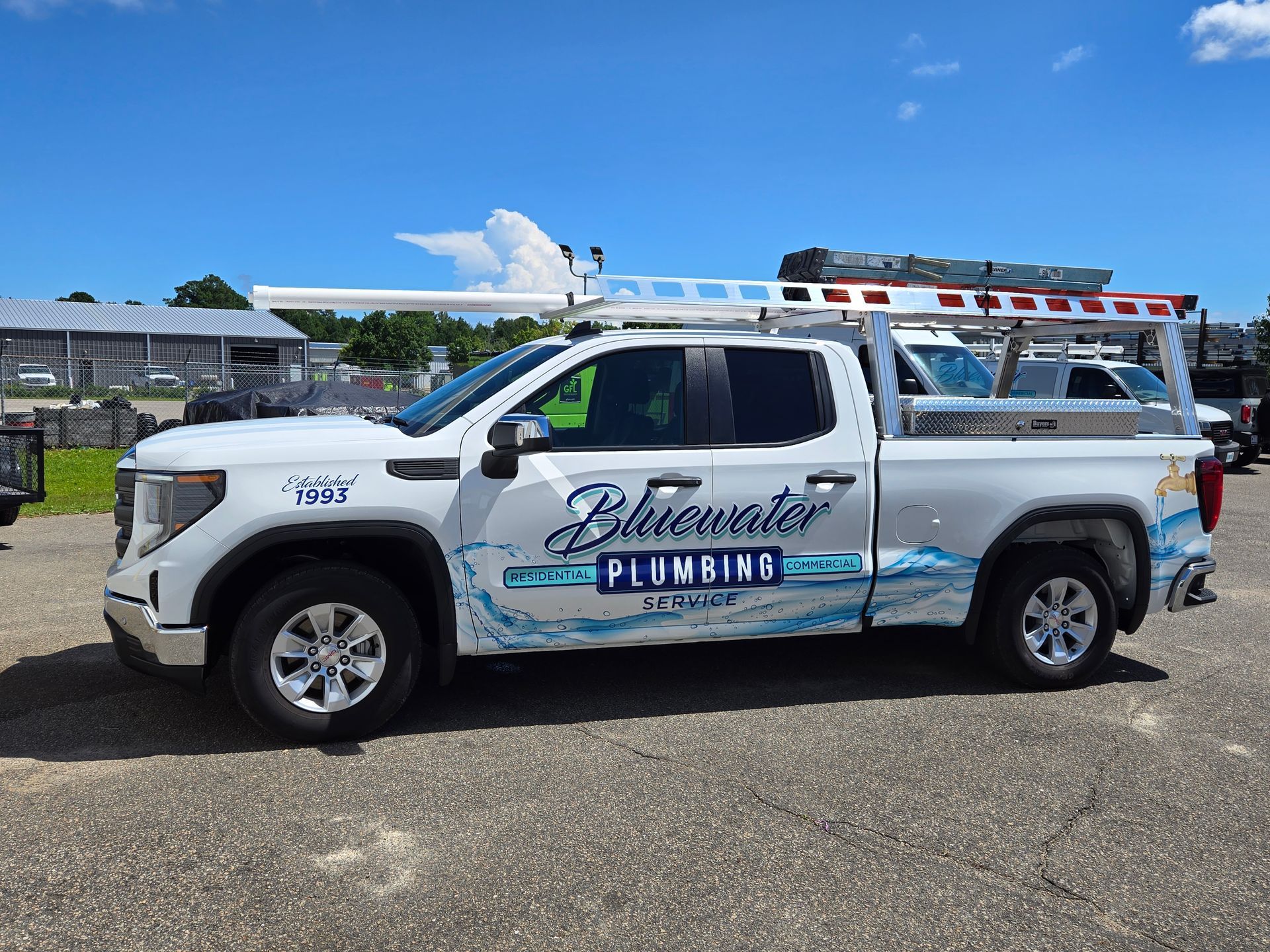 Man stands next to a white pickup truck with