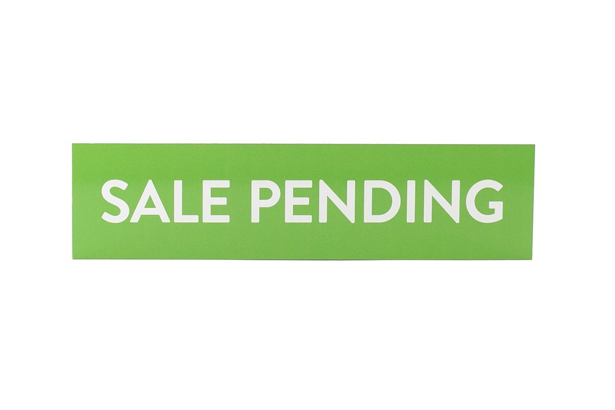 a green sale pending button on a white background .