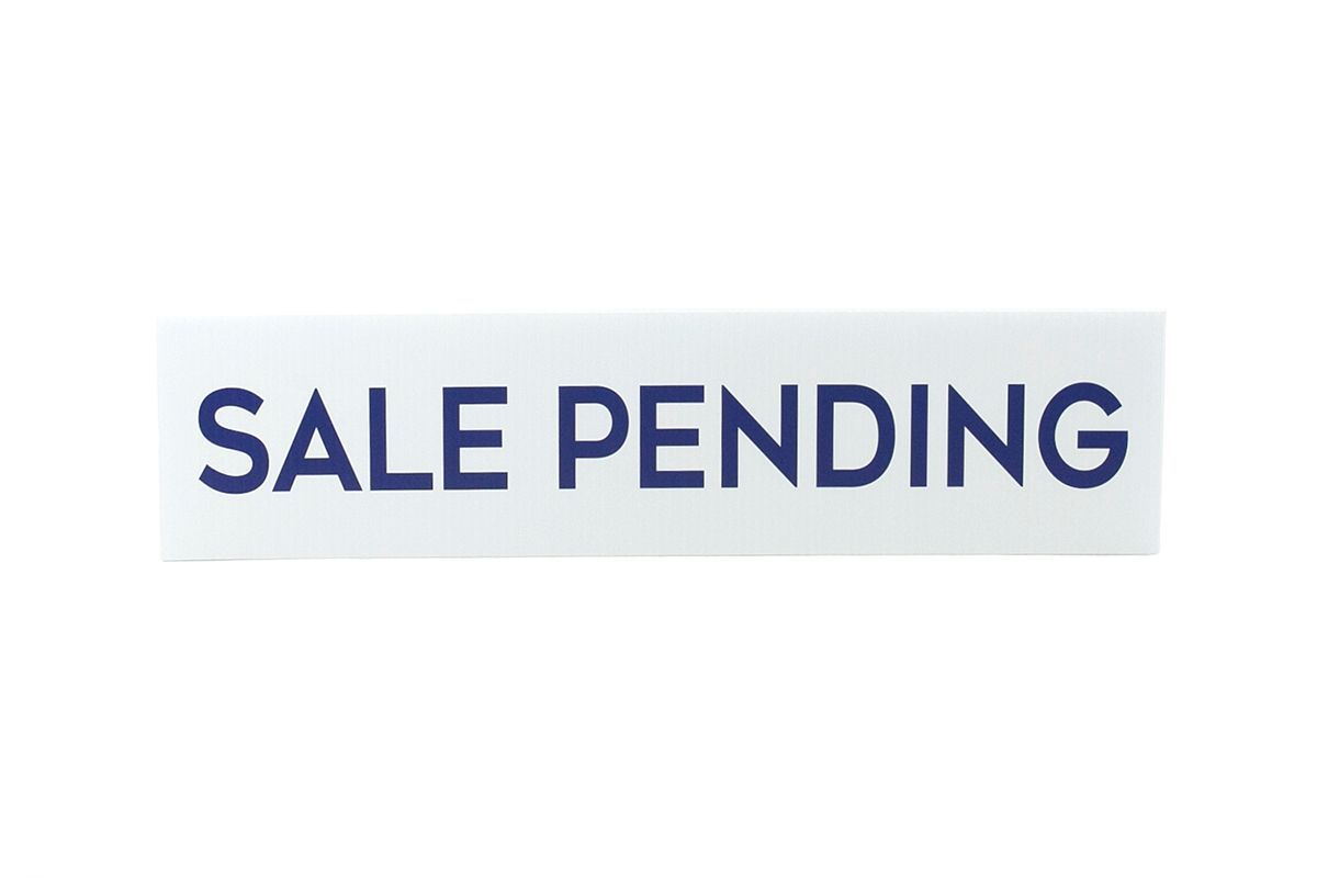 a white sign that says `` sale pending '' on a white background .