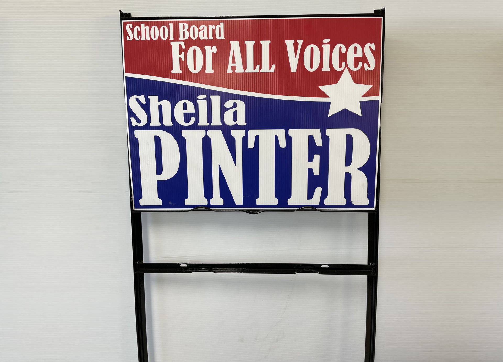 A sign that says school board for all voices on it.