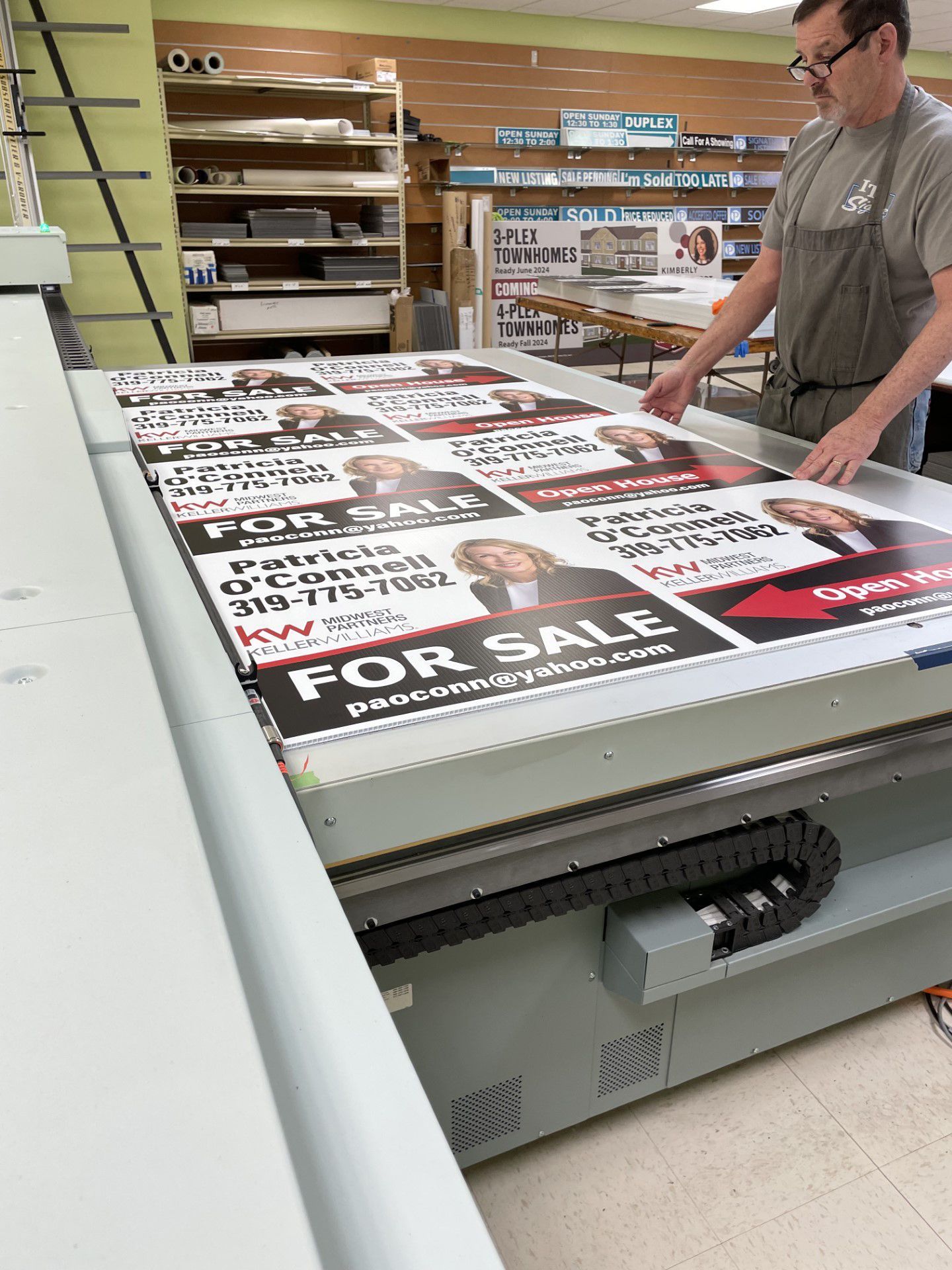 A man in front of a large printing machine.
