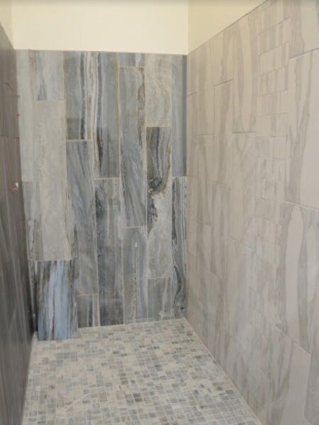 a bathroom with tiled walls and a tiled floor