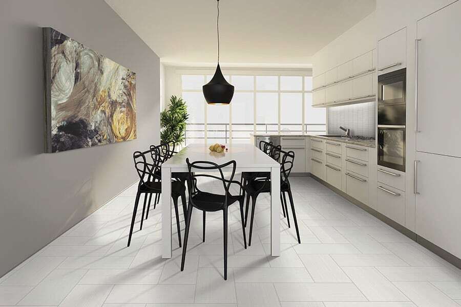 a kitchen with a table and chairs and a painting on the wall