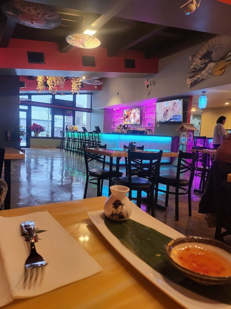 A table with a plate of food and a fork on it in a restaurant.