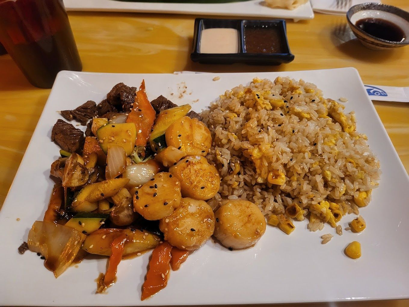A plate of food with shrimp and rice on a table.