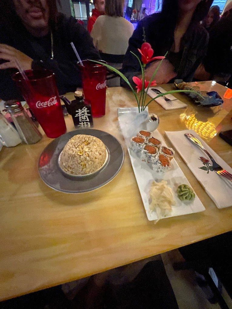 A table with plates of food and coca cola glasses on it