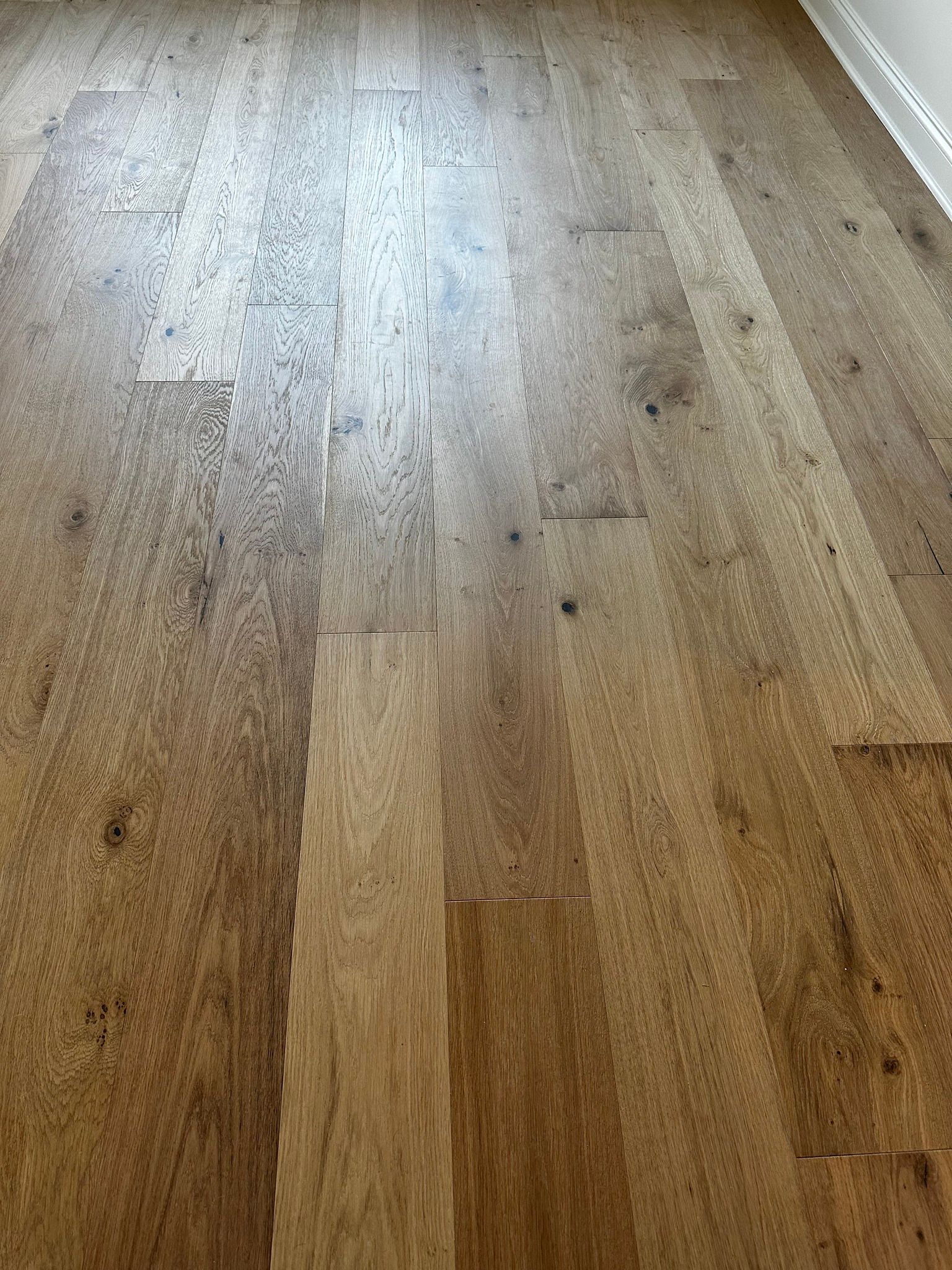 Wooden floor with a light brown, textured surface.
