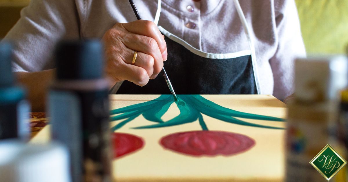 elderly person painting a flower on a canvas - Whispering Pines activities for assisted living homes