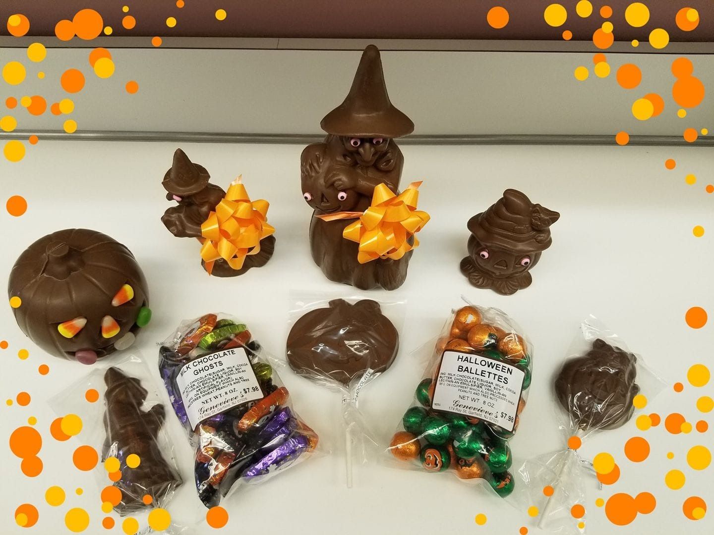 Chocolate Halloween treats on a white surface, with scattered orange and yellow confetti.