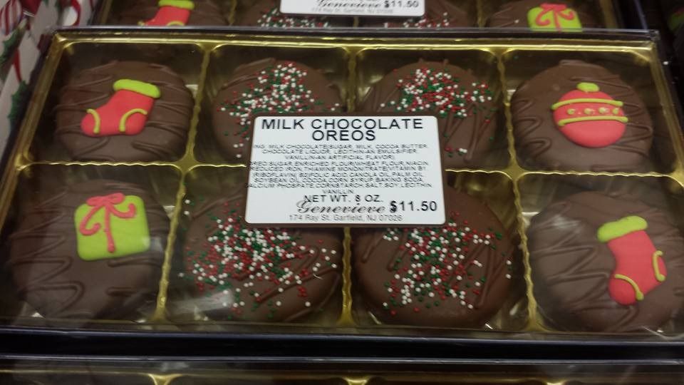 Box of milk chocolate Oreos, decorated for Christmas with festive frosting.