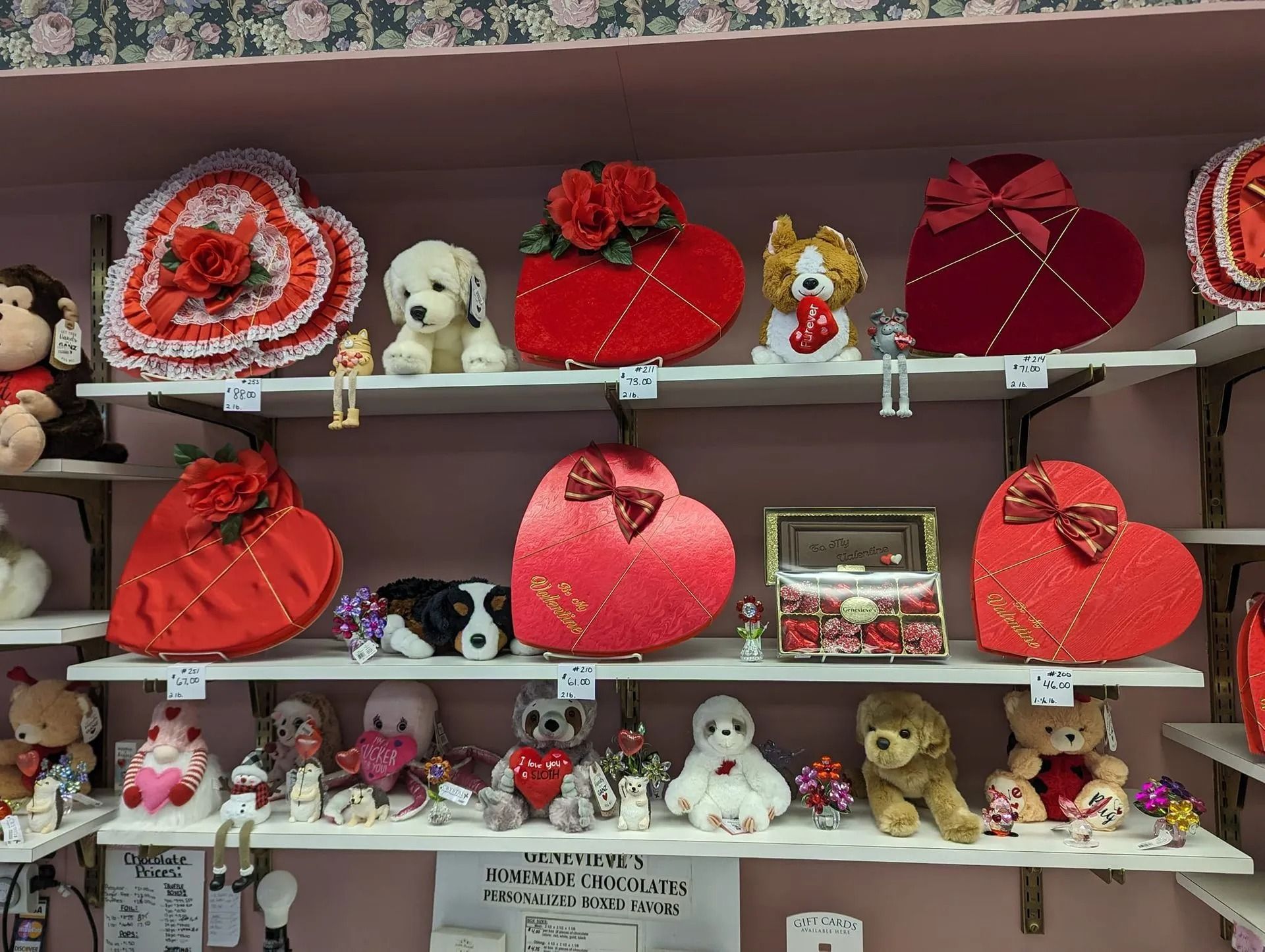 Shelves filled with Valentine's Day heart-shaped boxes, stuffed animals, and decorations, primarily red and white.
