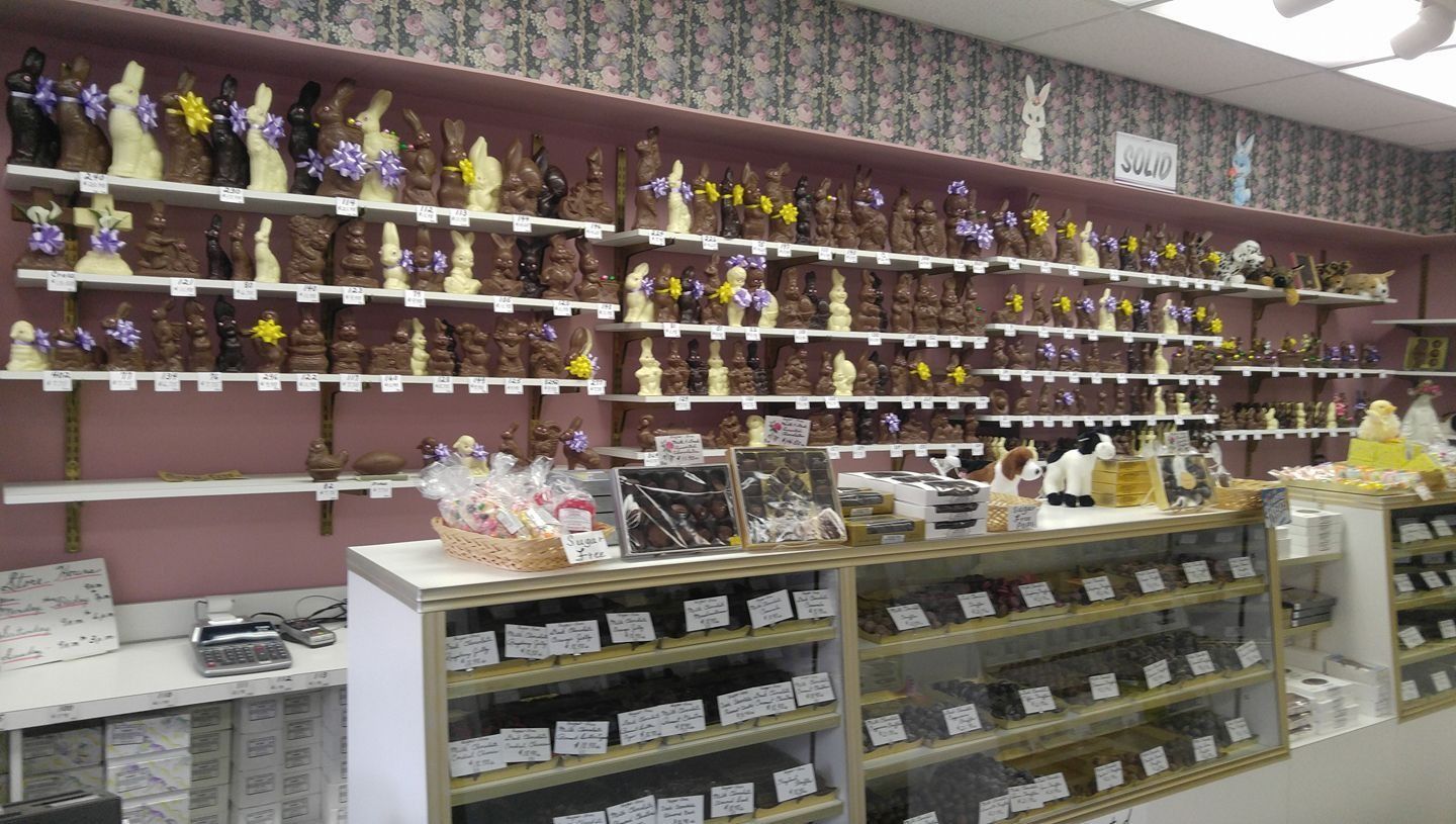 Chocolate shop interior with shelves of chocolate bunnies and candies.