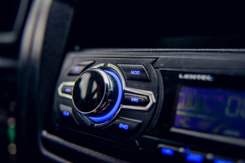 Car stereo system with blue illuminated dial and buttons.