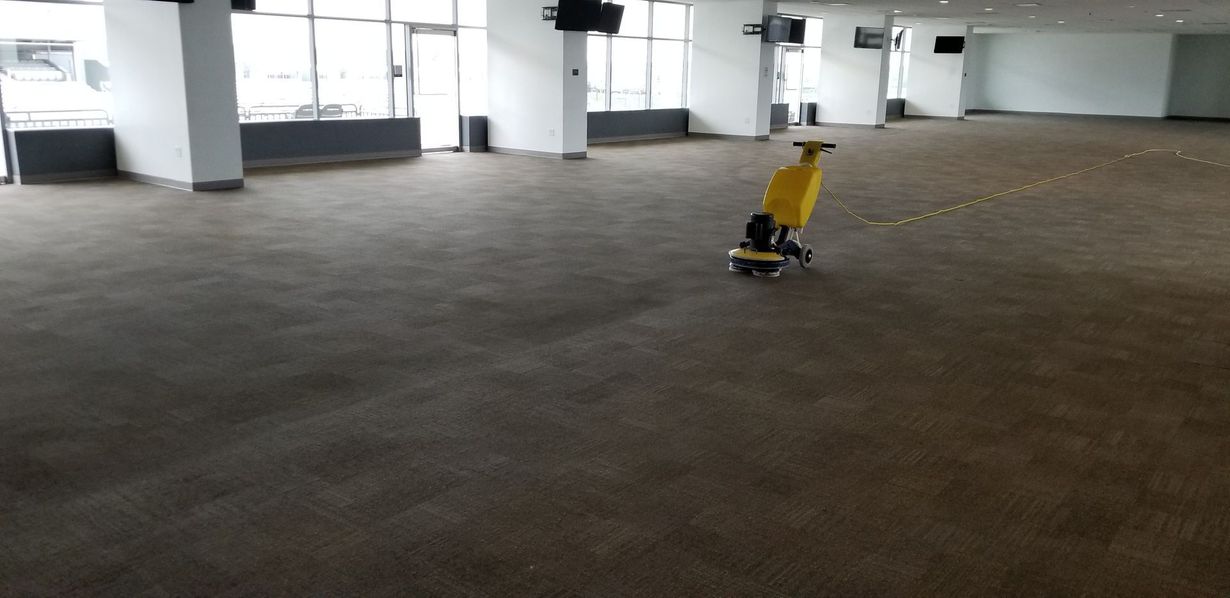 Vacuum cleaner on a carpeted hallway floor near a dark doorway