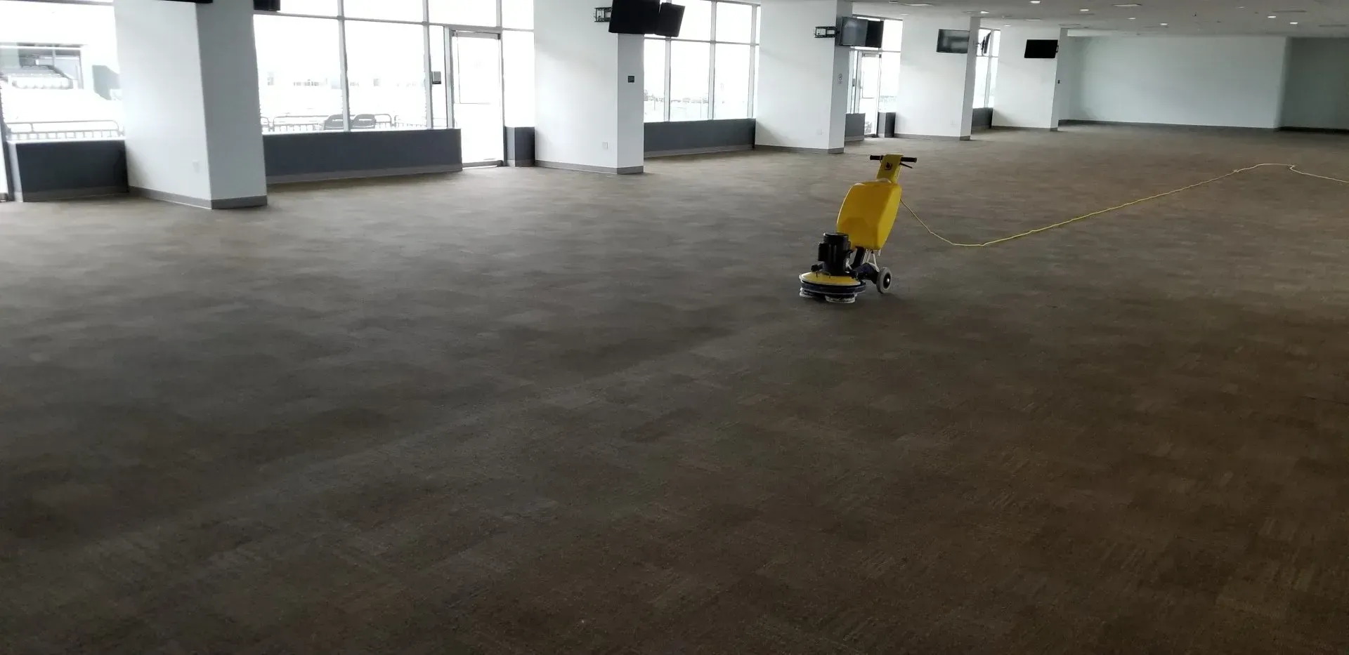 Empty indoor room with a small yellow chair on a skateboard-like base near the center.