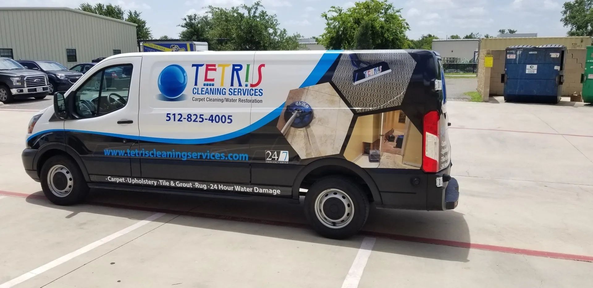 White TIKS service van with logo parked in an industrial lot on a sunny day