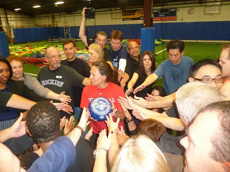 A woman in a red shirt with the word soccer on it.