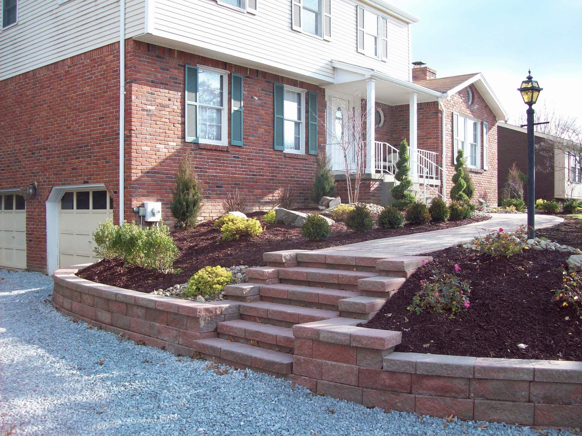 a brick house with stairs leading up to the front door