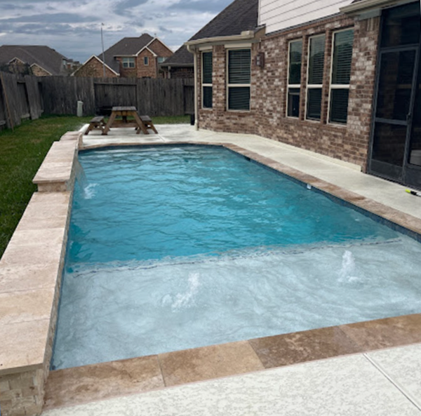 A large swimming pool in the backyard of a house