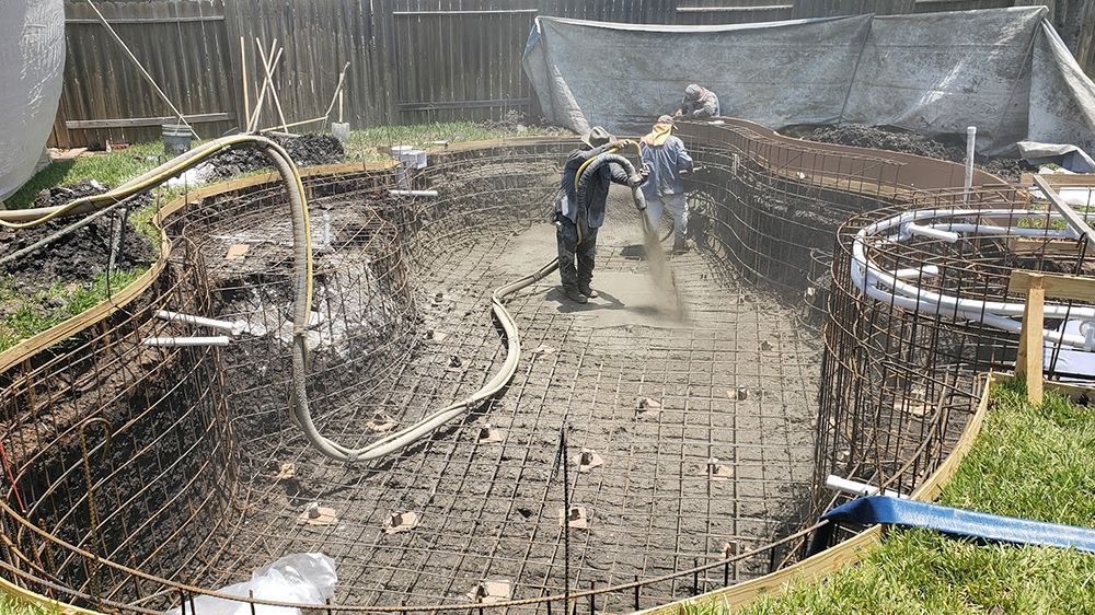 A swimming pool is being built in a backyard.