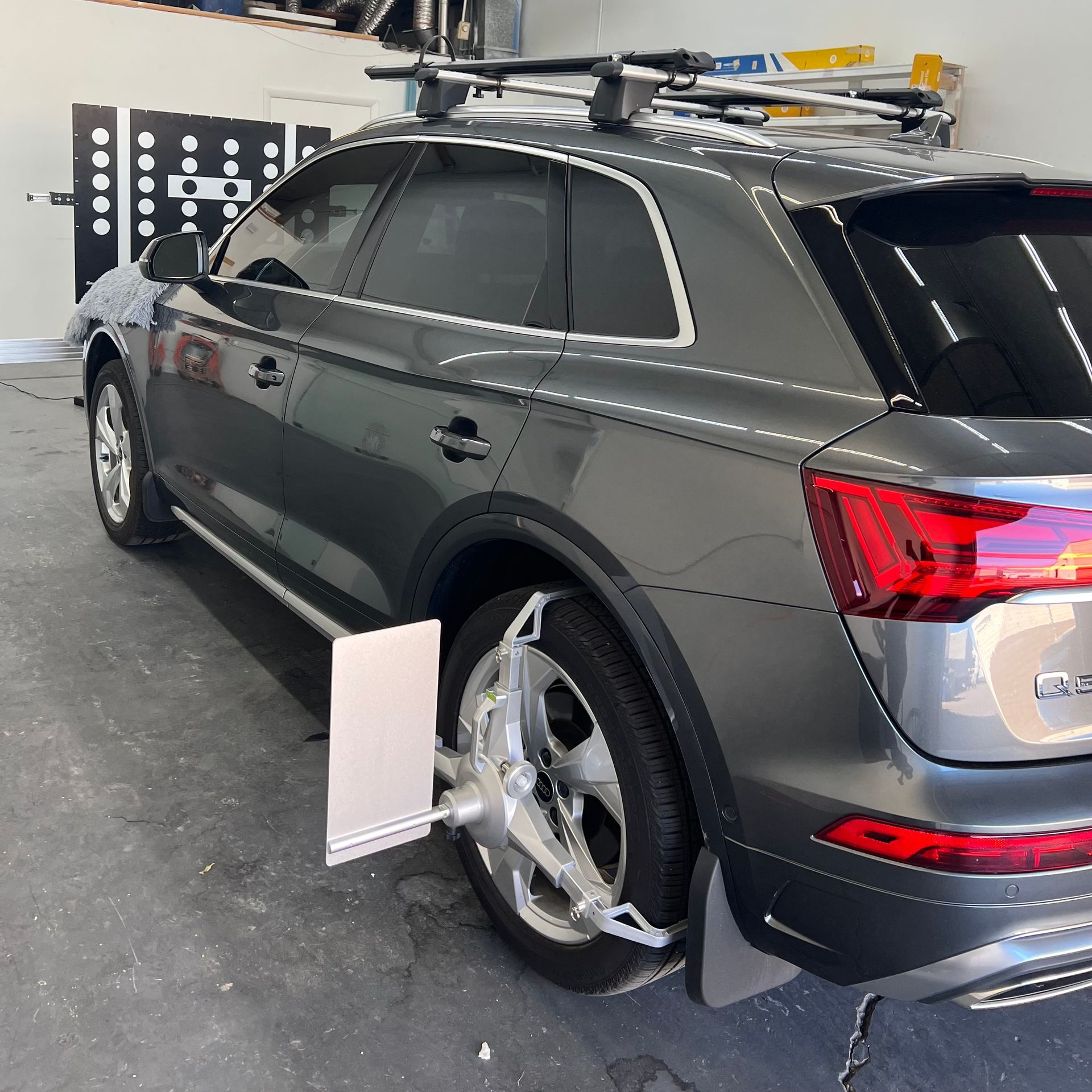 Gray SUV positioned for ADAS calibration after windshield replacement.