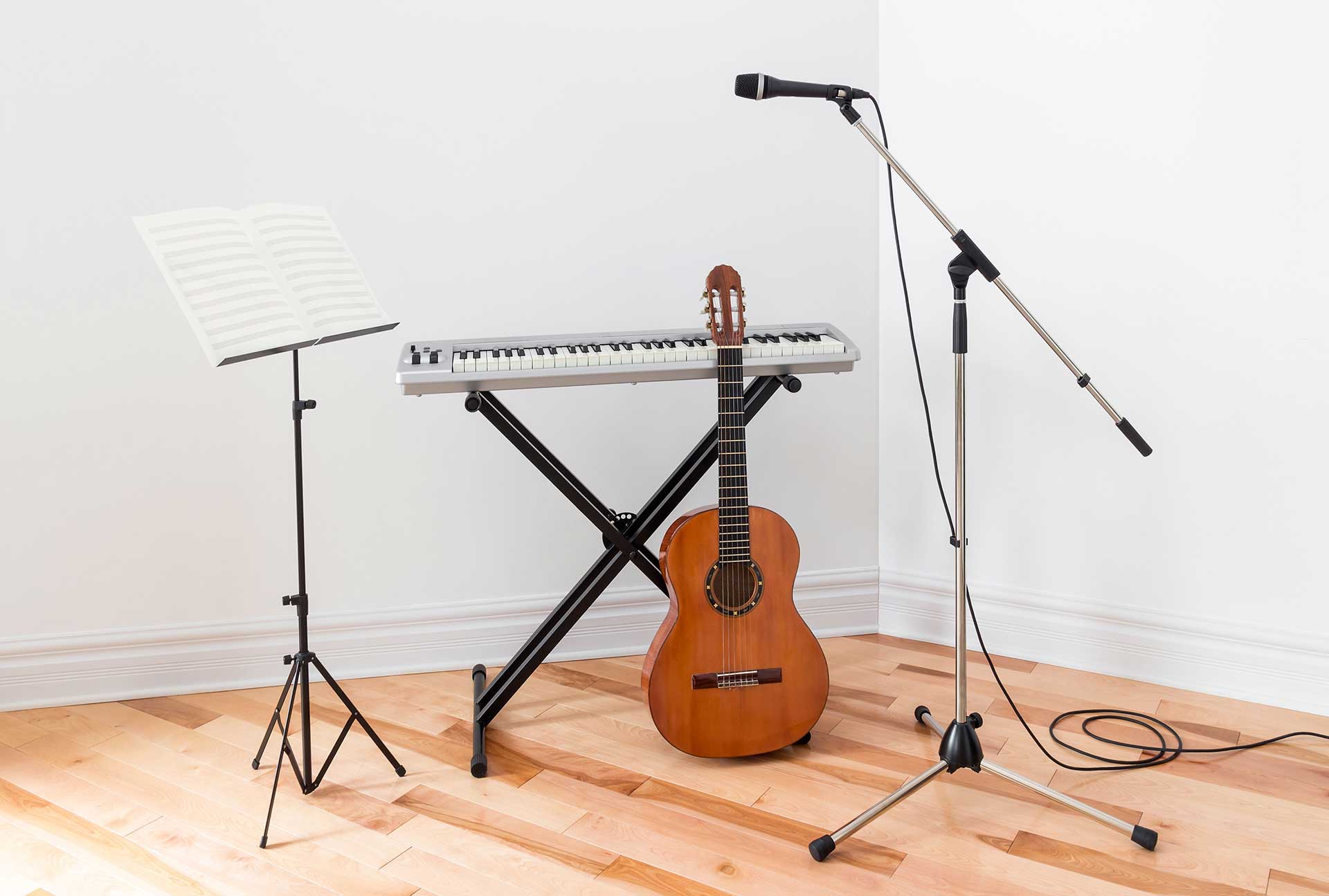 electric piano, guitar, and microphone stands